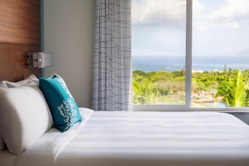 a bedroom with a bed and a window with a view at Residence Inn by Marriott Maui Wailea in Wailea