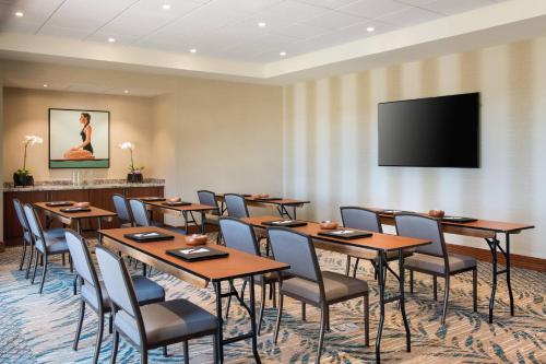 a conference room with tables and chairs and a flat screen tv at Residence Inn by Marriott Maui Wailea in Wailea
