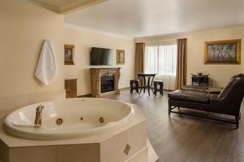 a large bathroom with a tub and a living room at The Davenport Tower, Autograph Collection in Spokane
