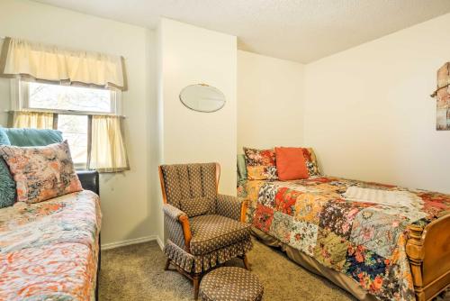 a bedroom with a bed and a chair and a chair at Charming Craftsman Home in Downtown Bartlesville! in Bartlesville