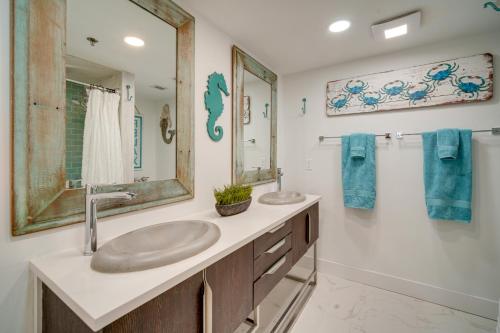 a bathroom with two sinks and a mirror at Atlantic City Condo with Community Pool! in Atlantic City