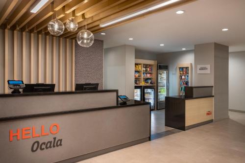 an office lobby with a hello oakola reception desk at TownePlace Suites by Marriott Ocala in Rolling Ranches