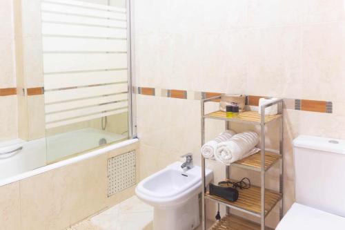 a bathroom with a white toilet and a sink at Appartement Haut Standing Central Corniche in Tangier