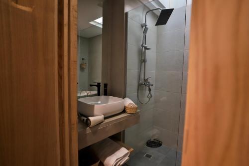 a bathroom with a sink and a shower at Moon house in Ville Nouvelle