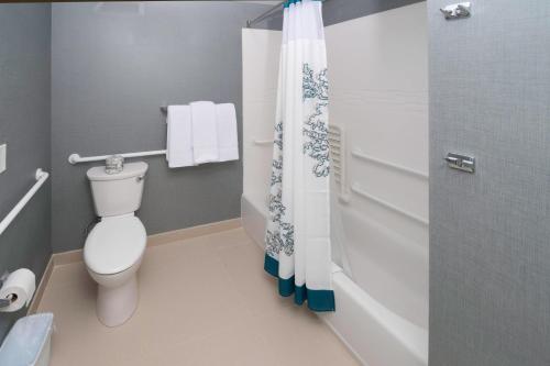 a bathroom with a toilet and a shower curtain at Residence Inn by Marriott Augusta in Augusta