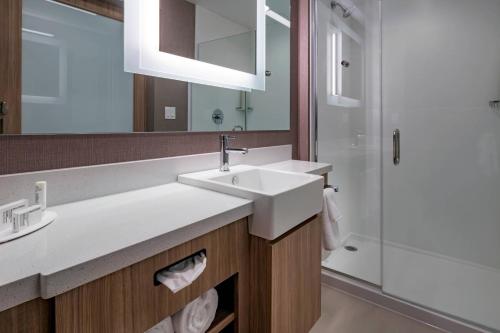 a bathroom with a sink and a shower at SpringHill Suites By Marriott Wrentham Plainville in Wrentham