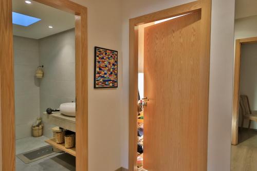 a door leading into a room with a bathroom at Moon house in Ville Nouvelle