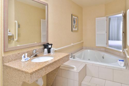 a bathroom with a sink and a bath tub at Fairfield Inn and Suites by Marriott Birmingham / Bessemer in Bessemer