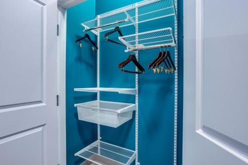 a walk in closet with baskets and hangers at TownePlace Suites by Marriott Chicago Waukegan Gurnee in Waukegan