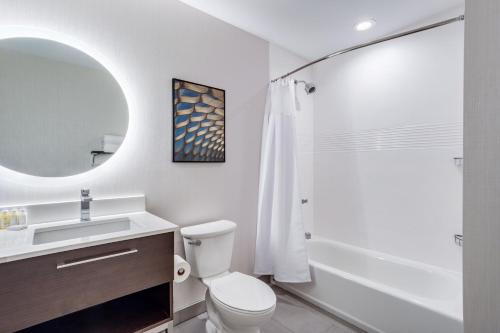 a bathroom with a toilet and a sink and a shower at TownePlace Suites by Marriott Chicago Waukegan Gurnee in Waukegan