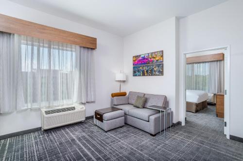 a hotel room with a couch and a bed at TownePlace Suites by Marriott Chicago Waukegan Gurnee in Waukegan