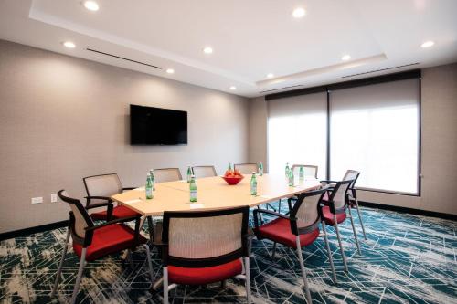 a conference room with a table and chairs at TownePlace Suites by Marriott Chicago Waukegan Gurnee in Waukegan