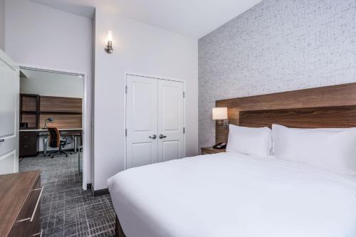 a bedroom with a large bed and a desk at TownePlace Suites by Marriott Chicago Waukegan Gurnee in Waukegan