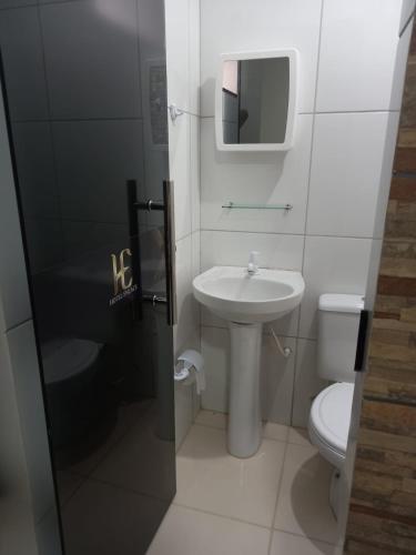 a small bathroom with a sink and a toilet at Hotel Enlace in Ji-Paraná