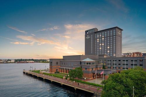 a large building next to a body of water at Renaissance Portsmouth-Norfolk Waterfront Hotel in Portsmouth