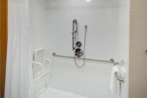 a shower in a bathroom with a white shower curtain at Fairfield Inn & Suites by Marriott Hollister in Hollister