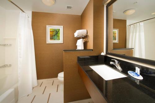 a bathroom with a sink and a mirror and a toilet at Fairfield Inn & Suites by Marriott Arundel Mills BWI Airport in Hanover