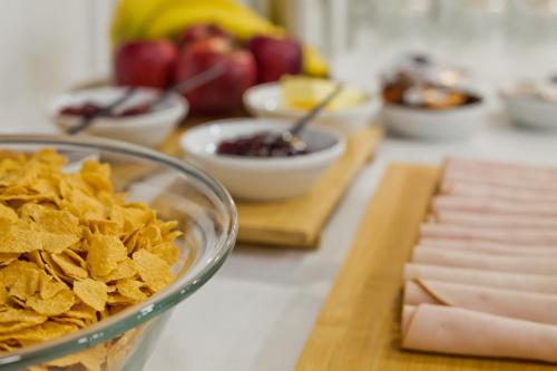 a bowl of crisps and a bowl of food on a counter at Diana Art Boutique Hotel in Rhodes Town