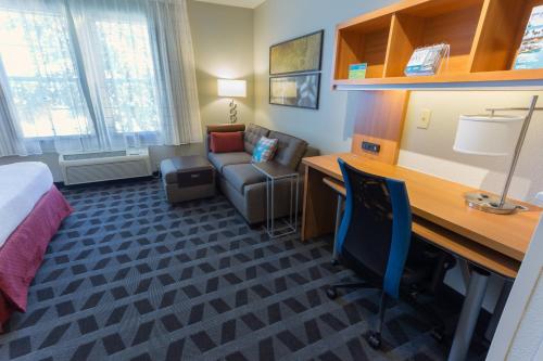 a hotel room with a desk and a bed and a couch at TownePlace Suites by Marriott Sunnyvale Silicon Valley in Sunnyvale