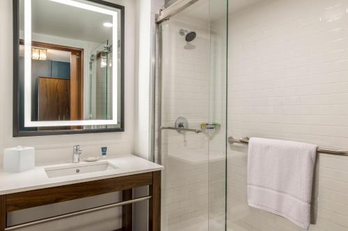 a bathroom with a sink and a shower at Four Points by Sheraton Monterrey Airport in Monterrey