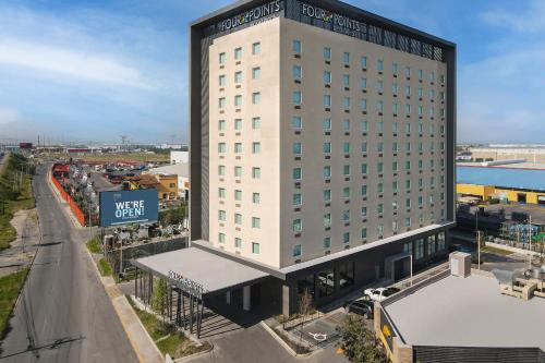 a tall white building with a view of a street at Four Points by Sheraton Monterrey Airport in Monterrey