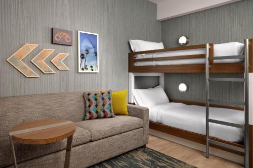 a living room with a couch and bunk beds at Element Anaheim Resort Convention Center in Anaheim