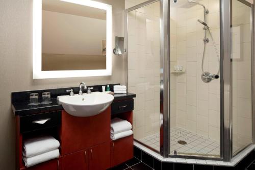 a bathroom with a sink and a shower at Le Westin Tremblant in Mont-Tremblant