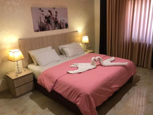 una camera da letto con un letto e due asciugamani di Suzan Hotel Apartments ad Amman