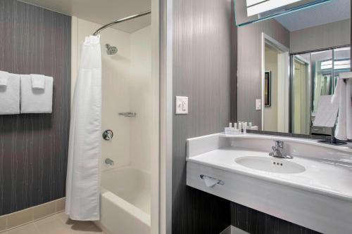a bathroom with a sink and a shower at Courtyard by Marriott Basking Ridge in Basking Ridge