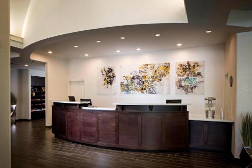 a lobby with a reception desk and paintings on the wall at Residence Inn by Marriott Tallahassee Universities at the Capitol in Tallahassee