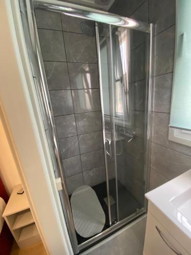 a shower with a chair in a bathroom at Casa Rocha in Pinhão