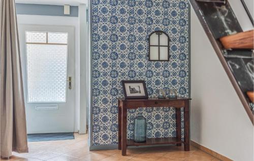 a hallway with a blue and white patterned wall at 2 Bedroom Lovely Home In Tönning in Tönning