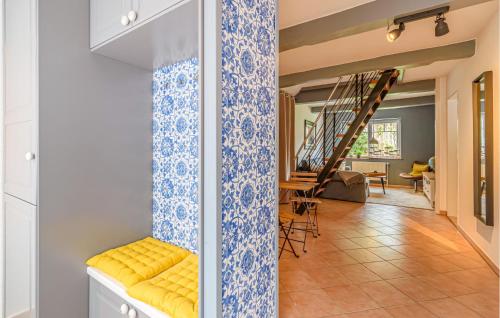 a hallway with a yellow bench and a living room at 2 Bedroom Lovely Home In Tönning in Tönning