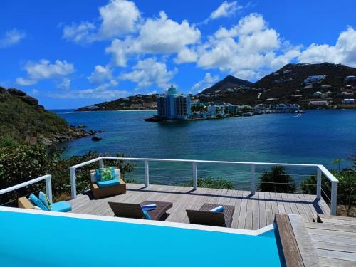 a balcony with a view of the water at PERLE DES ANTILLES in Oyster Pond