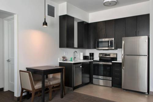 a kitchen with stainless steel appliances and a table at Residence Inn by Marriott Lancaster in Lancaster