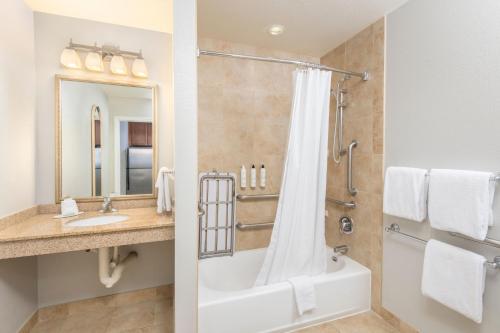 a bathroom with a tub and a sink and a shower at TownePlace Suites by Marriott Tucson Williams Centre in Tucson