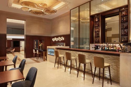 a bar in a restaurant with tables and chairs at Sheraton Istanbul Levent in Istanbul