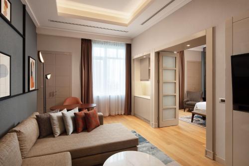 a living room with a couch and a tv at Sheraton Istanbul Levent in Istanbul
