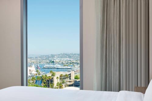 a bedroom with a large window with a view of a ship at Residence Inn by Marriott San Diego Downtown/Bayfront in San Diego