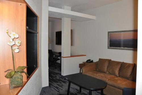 a living room with a couch and a table at Fairfield Inn & Suites Ukiah Mendocino County in Ukiah