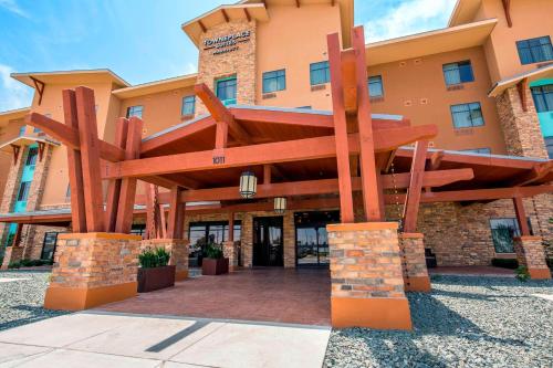 a building with a large wooden structure in front of it at TownePlace Suites by Marriott Big Spring in Big Spring