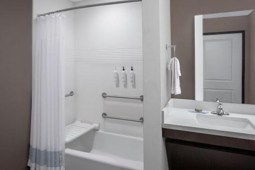 a white bathroom with a sink and a shower at TownePlace Suites by Marriott Big Spring in Big Spring