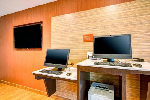 a room with two computer monitors on a desk at TownePlace Suites by Marriott Big Spring in Big Spring