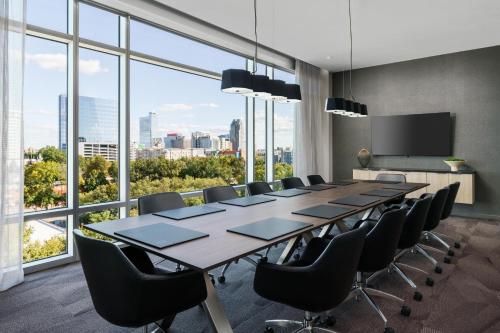 a conference room with a long table and chairs at AC Hotel By Marriott Raleigh Downtown in Raleigh