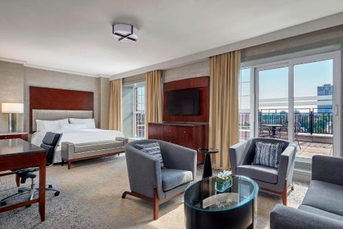a hotel room with a bed and a desk and chairs at The Westin Nova Scotian in Halifax