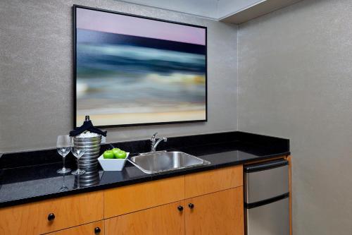 a kitchen with a sink and a tv on the wall at The Westin Nova Scotian in Halifax