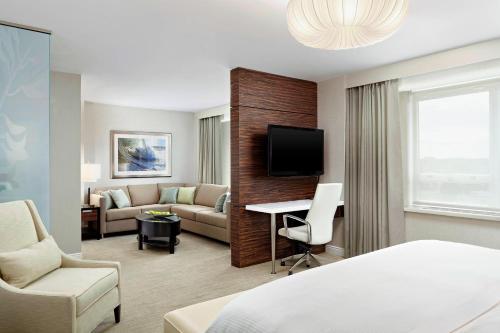 a hotel room with a bed and a living room at The Westin Nova Scotian in Halifax