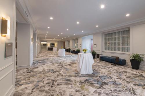 a large hallway with two tables in a building at The Westin Nova Scotian in Halifax