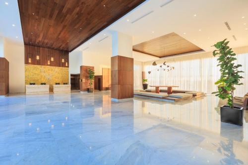 a lobby with a table and a potted plant at Courtyard by Marriott Mazatlan Beach Resort in Mazatlán