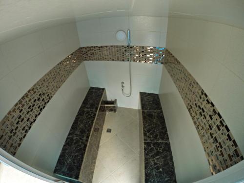 a bathroom with a walk in shower in a room at Hotel Casa Morales in Yopal